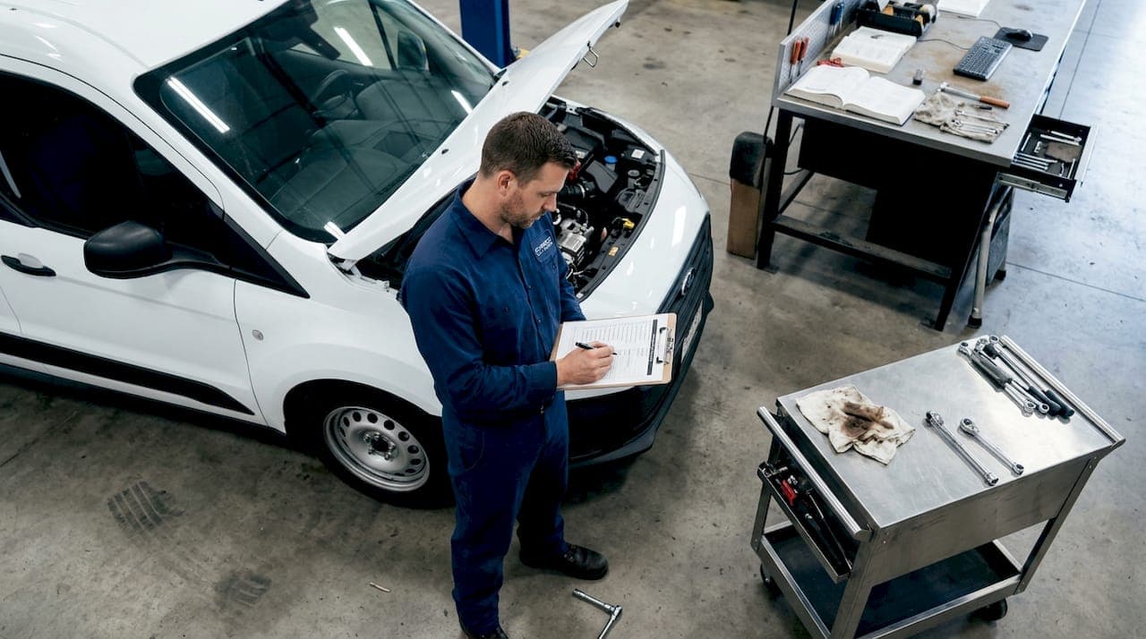 Mechanic completes fleet van inspection checklist